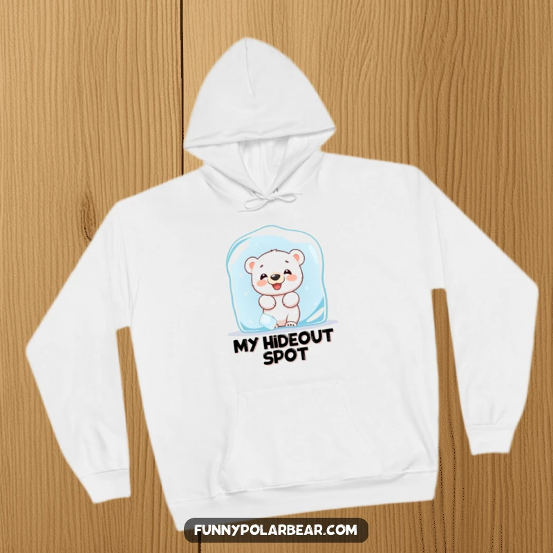 Funny hoodie featuring a giggling baby polar bear cub hiding behind a large ice block, offering a playful Arctic peek.